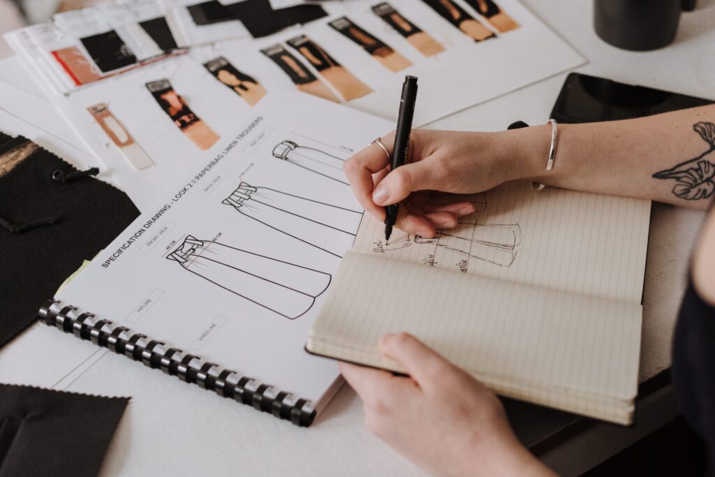 A person sketching a garment at Design Loft Sewing School
