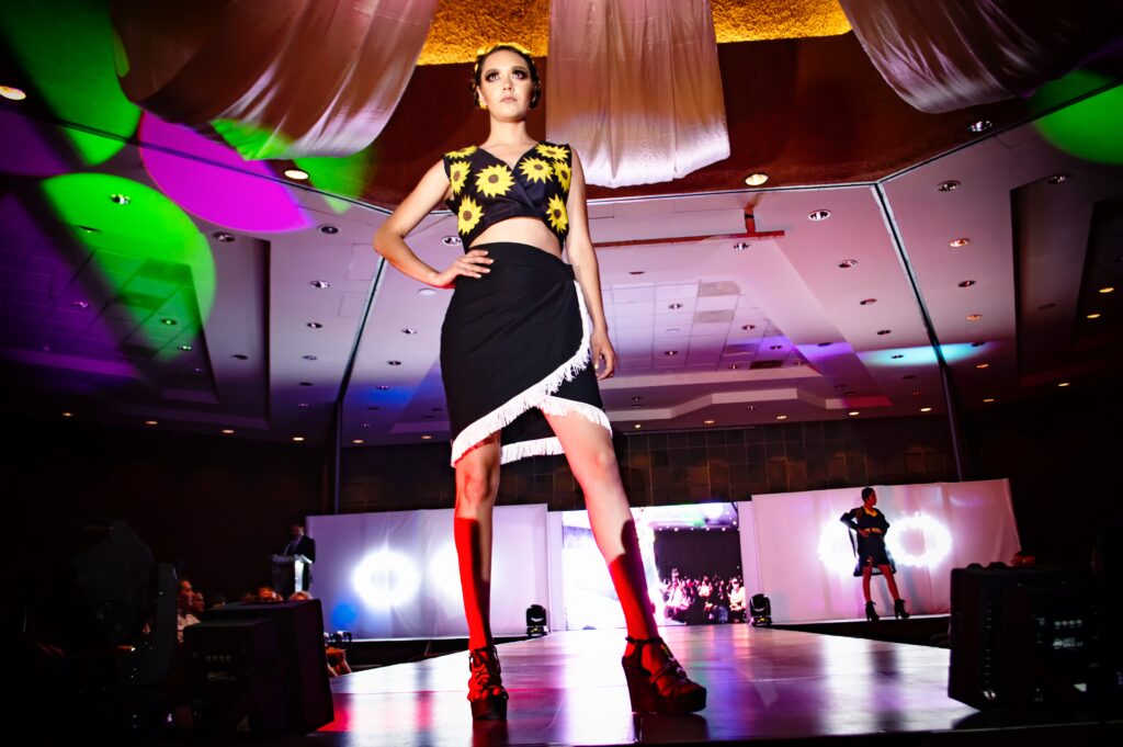 A fashion model walking down the runway during a fashion show at Design Loft Sewing School
