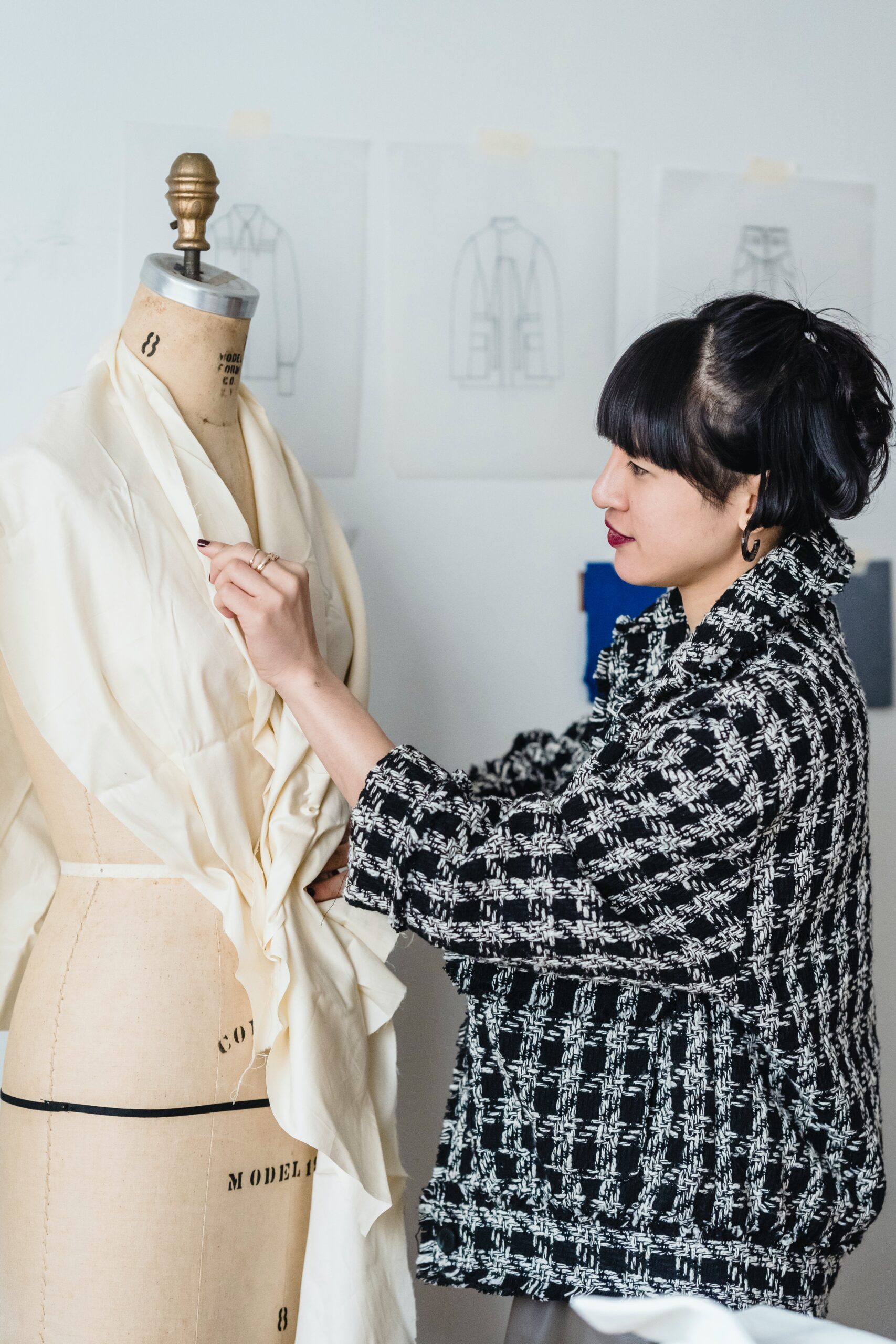 A person draping fabric on a fashion dummy at Design Loft Sewing School