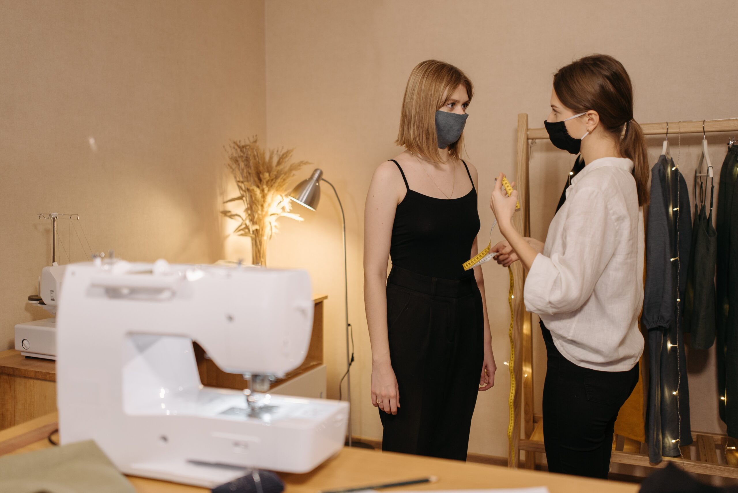A student taking measurements for a garment at Design Loft Sewing School